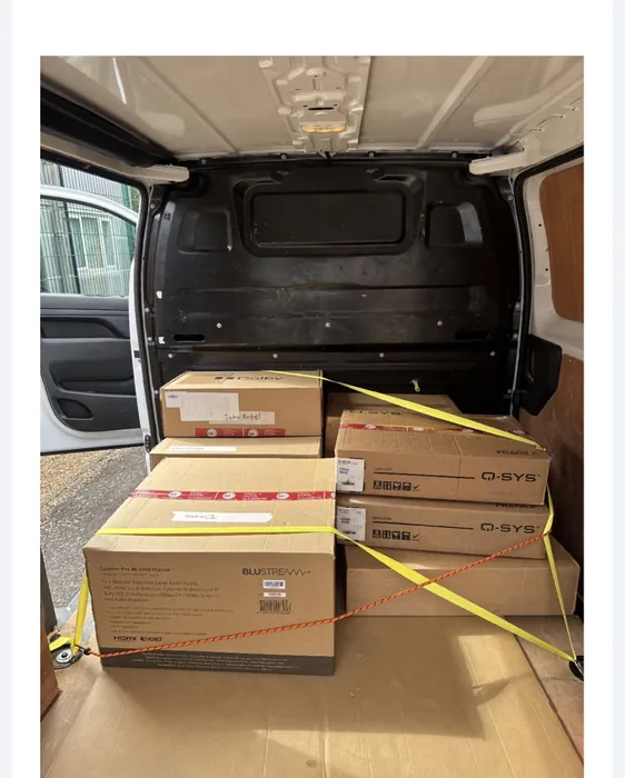 Professional audio-visual equipment collected and delivered on a dedicated vehicle — every box strapped and secured for a safe, careful journey. The kind of time-sensitive, high-value work our business clients rely on.