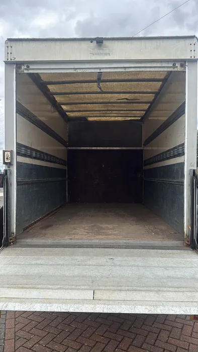 The clean, lined load area and tail-lift inside our Luton van. Plenty of room for a flat or small-house move, with blankets and straps to keep everything secure in transit.